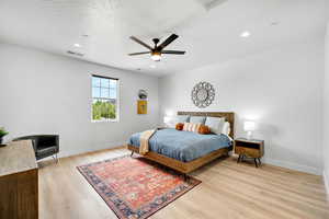 Bedroom featuring light wood finished floors, ceiling fan, and recessed lighting