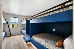 Bedroom featuring light wood finished floors and baseboards