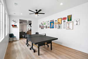 Recreation room featuring light wood finished floors, a ceiling fan, and recessed lighting