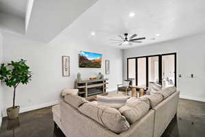 Living area featuring recessed lighting, concrete floors, a ceiling fan, and a textured ceiling