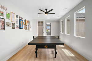 Rec room featuring light wood-type flooring, ceiling fan, and recessed lighting