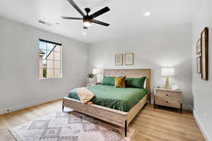 Bedroom featuring light wood finished floors, a ceiling fan, and recessed lighting