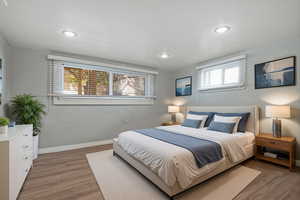 Bedroom with light wood-type flooring and recessed lighting