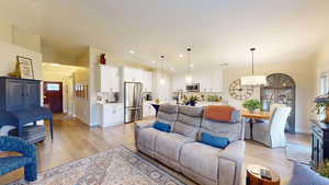 Living room featuring light wood-style flooring and recessed lighting