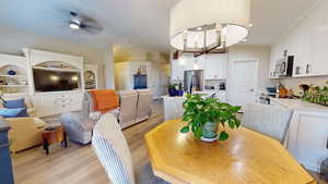 Dining room with light wood-style floors, recessed lighting, and a ceiling fan. Dining room light in picture is not included. It will bet replaced with a different light fixture!