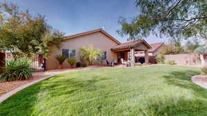 Back of property featuring a fenced backyard, a patio, stucco siding, and a tile roof