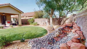 Fenced backyard featuring a patio and a ceiling fan