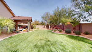 Fenced backyard with a patio, an outdoor hangout area, and a gazebo