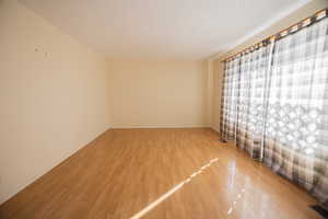 Empty room featuring light wood-style flooring and baseboards