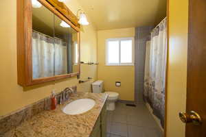 Bathroom with tile patterned flooring and vanity