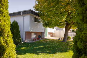 Rear view of property with a patio and brick siding