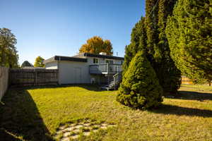 Fenced backyard featuring stairway and a wooden deck