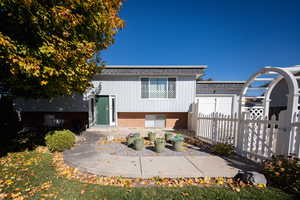View of front facade featuring brick siding and a gate