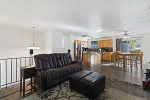Living area featuring dark wood finished floors and a ceiling fan