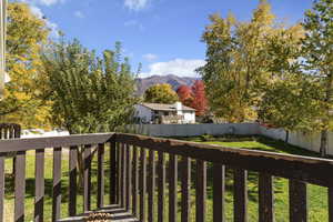 Deck featuring a fenced backyard and a mountain view