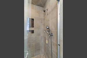 Full bath featuring a shower stall