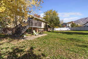 View of yard featuring a patio, stairs, and a deck with mountain view
