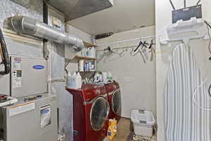 Laundry room with heating unit and washer and dryer