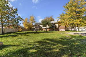Fenced backyard with a balcony