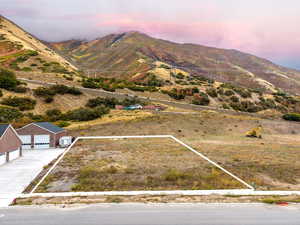 Aerial view at dusk of property boundaries highlighted and a mountain view