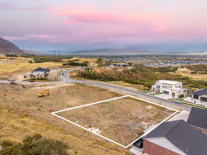 Aerial view of property and surrounding area with mountains and property boundaries highlighted