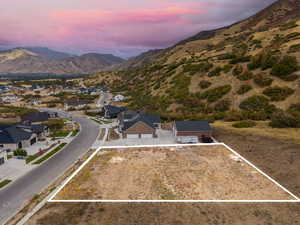 Aerial view at dusk of property parcel outlined and a mountain view
