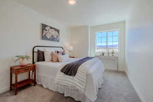Carpeted bedroom featuring baseboards