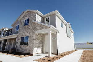 View of front of home with stone siding and stucco siding