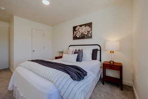 Bedroom with light carpet and recessed lighting