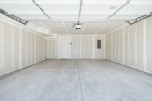 Garage with electric panel and a garage door opener