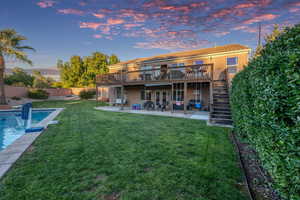 Rear view of property with a patio area, stairway, a wooden deck, stucco siding, and a tiled roof