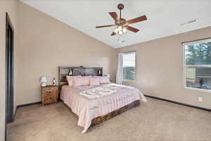 Bedroom featuring vaulted ceiling, carpet flooring, and a ceiling fan