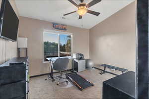 Office space with light carpet and a ceiling fan