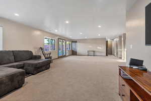 Living room with light carpet and recessed lighting