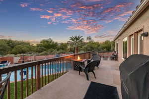 Patio terrace at dusk featuring a fire pit, area for grilling, a patio area, and a fenced backyard