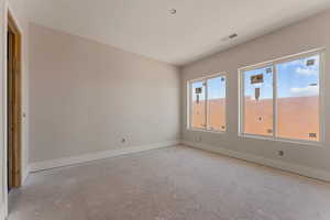 Spare room featuring visible vents and baseboards