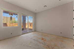 Unfurnished room featuring visible vents and unfinished concrete flooring