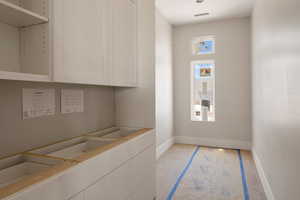 Interior space featuring visible vents, light wood-style flooring, and baseboards