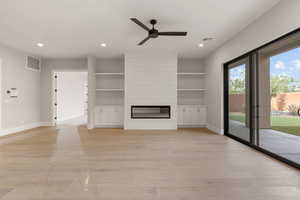 Unfurnished living room with ceiling fan, a fireplace, light wood finished floors, and recessed lighting