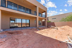 Back of property with a patio, stucco siding, and a balcony
