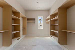 Spacious closet featuring visible vents
