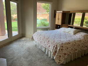 Primary Suite Bedroom, Carpeted with multiple windows and access to exterior