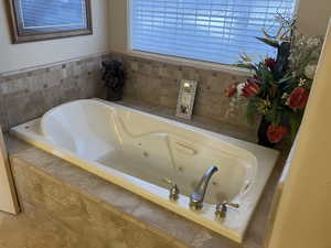 Primary Suite Bathroom featuring a jetted tub
