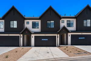 Modern farmhouse with driveway and stucco siding
