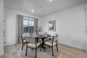 Dining space with light wood-style flooring and recessed lighting