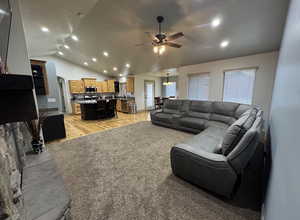 Living area with recessed lighting, a ceiling fan, vaulted ceiling, and arched walkways