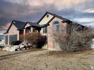 View of front of property with brick siding and a garage