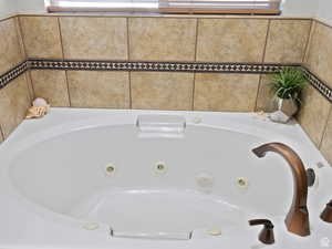 Room details with a whirlpool tub