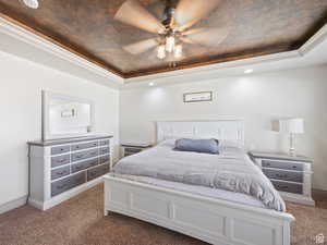 Bedroom featuring ceiling fan, a raised ceiling, carpet floors, recessed lighting, and baseboards