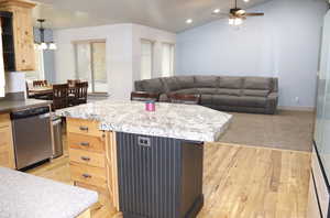 Kitchen with light wood finish cabinets, dishwasher, lofted ceiling, light wood-type flooring, and glass insert cabinets